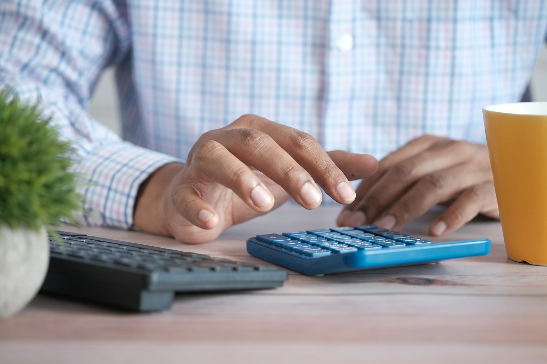 man budgeting using a calculator